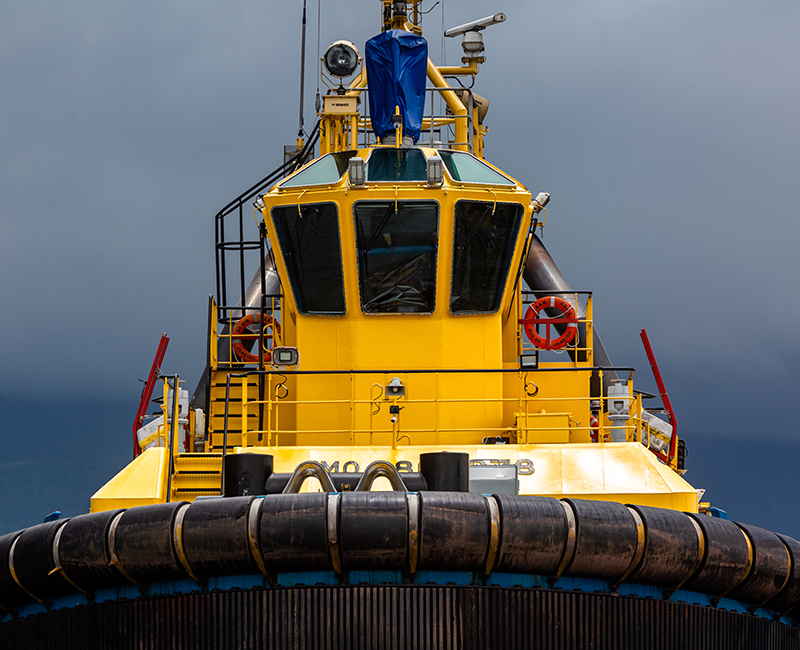 Bow-on view of a yellow SAAM towage tug
