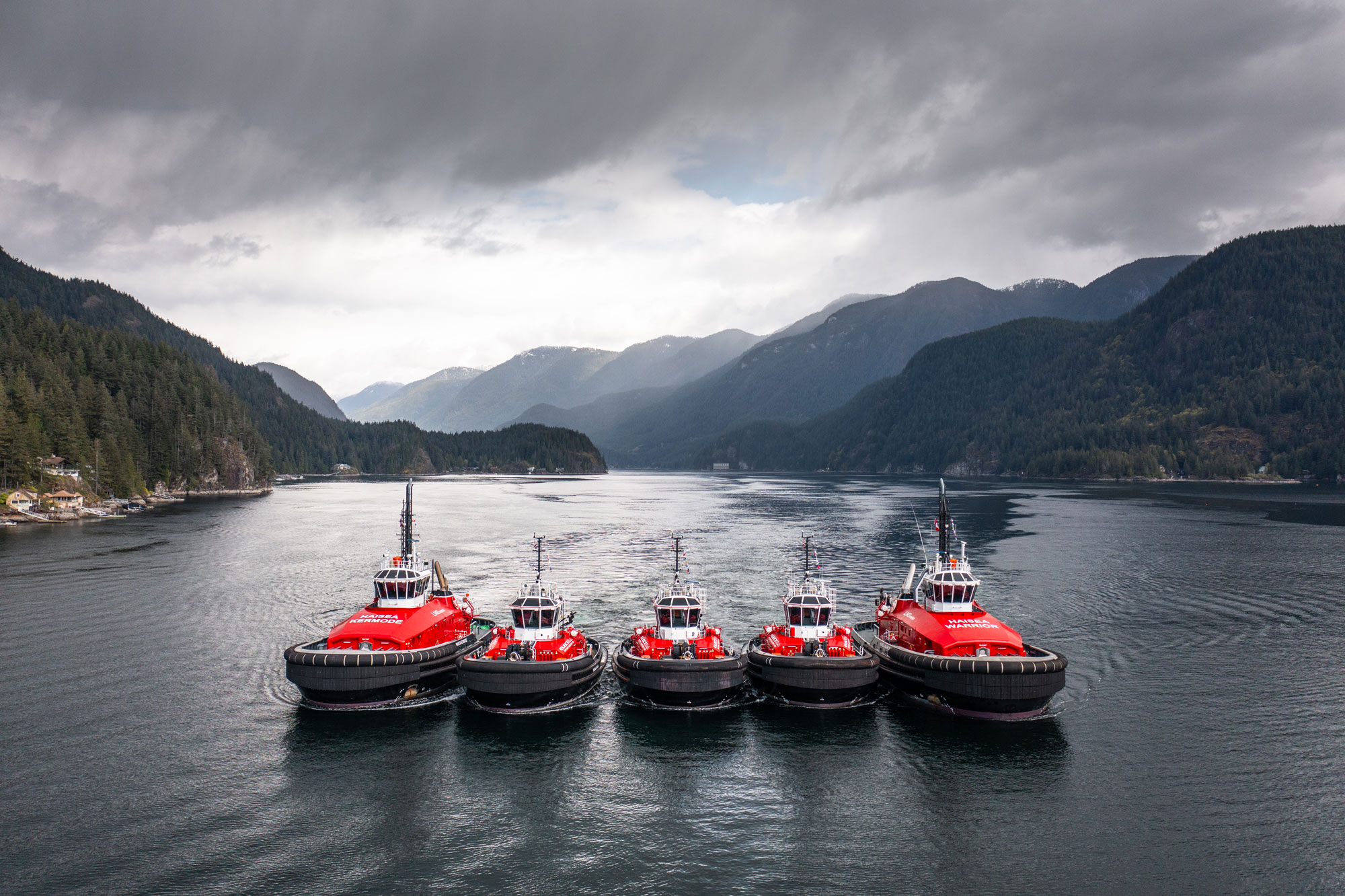 Five HaiSea Marine tugs in formation in a fjord