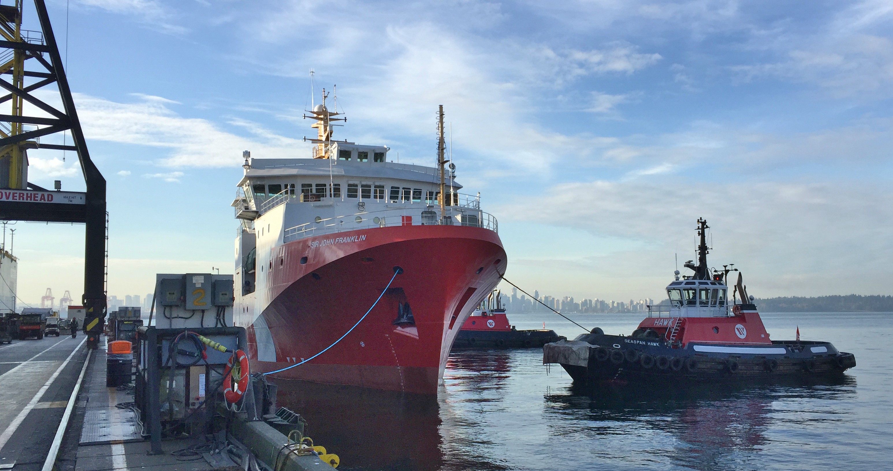 The Sir John Franklin alongside a Seaspan tug at a North Vancouver dock