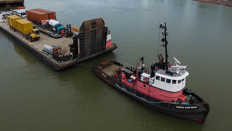 The tug North Arm Wave towing a loaded barge